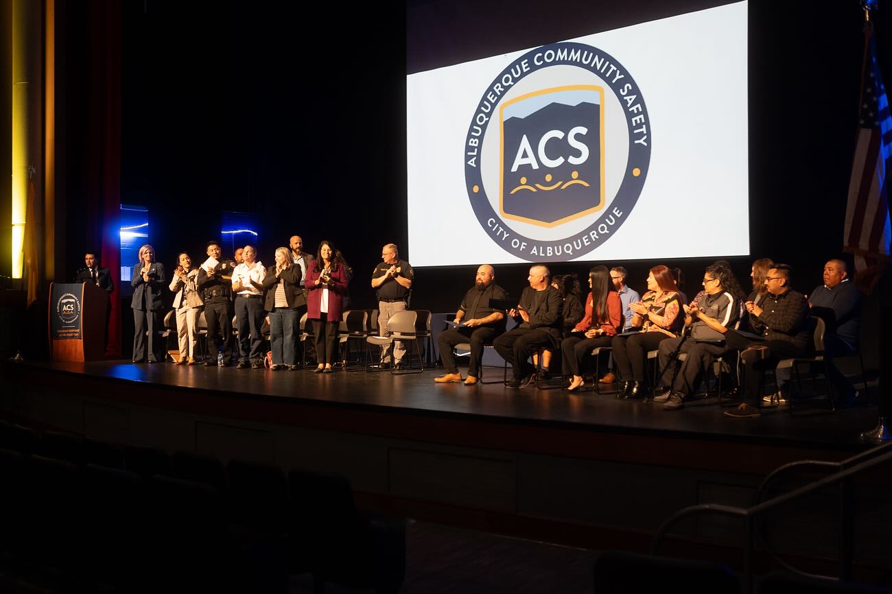 City leadership and ACS Academy graduates on a stage at a graduation ceremony