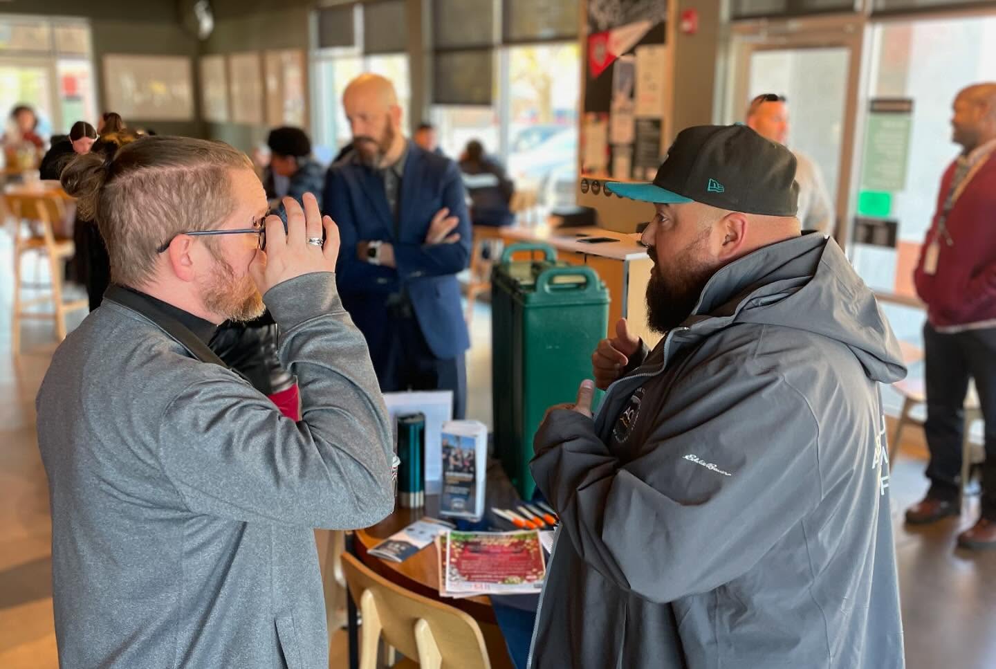 A community member having a conversation with an ACS responder in a coffee shop