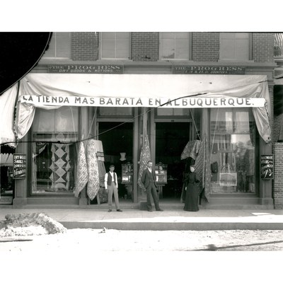 A vintage black and white photo of a storefront.