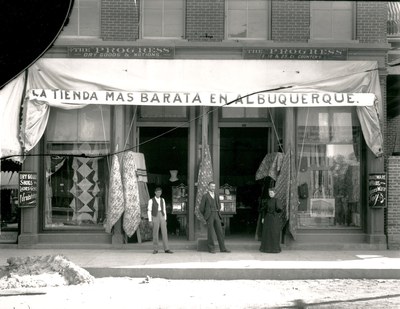 A vintage black and white photo of a storefront.