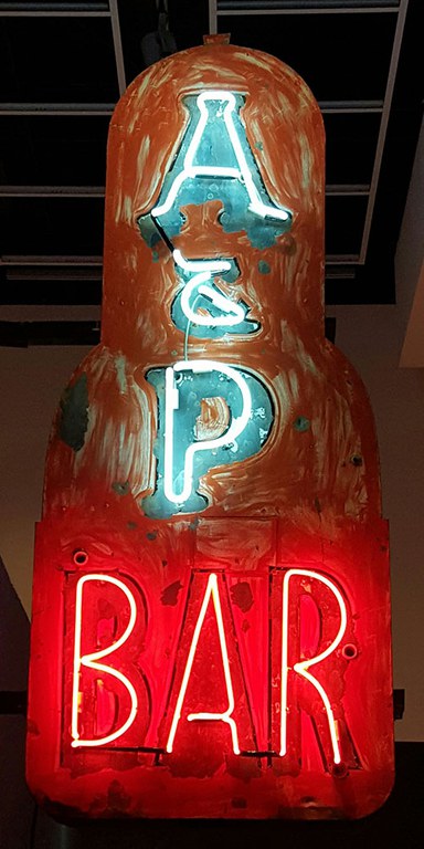A vintage neon sign featuring the letters A & P in blue and the word Bar in red.