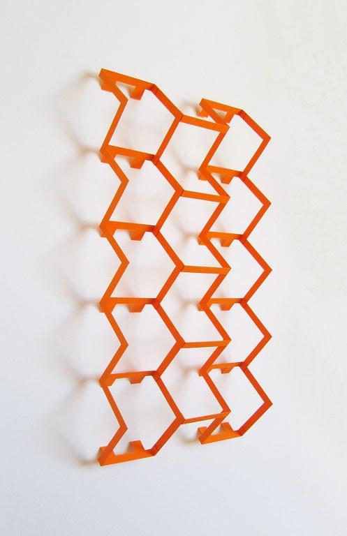 A modern, 3D artwork featuring rows of squares in orange. Part of the Unfolding Tradition exhibition at Albuquerque Museum 2019.