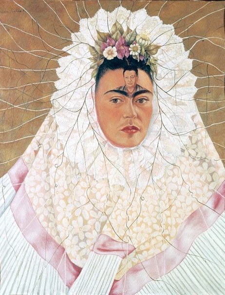 A self portrait done by Frida Kahlo, called Diego on My Mind, featuring the artist wearing a large white headpiece the frames her face. A small painting of Diego appears on her forehead.