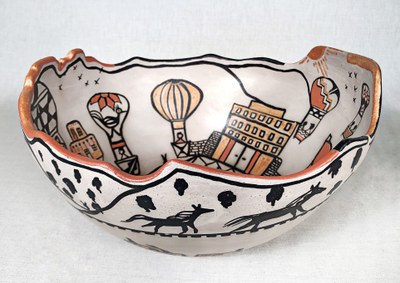 A large ceramic bowl with balloon drawings