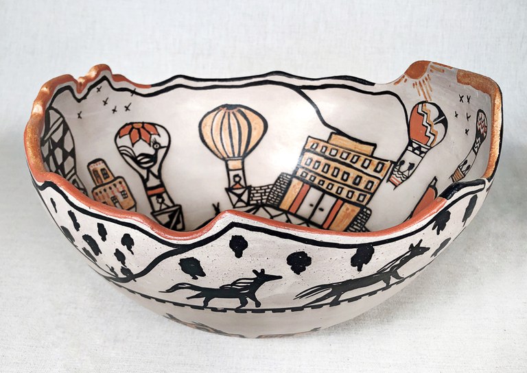 A large ceramic bowl with balloon drawings