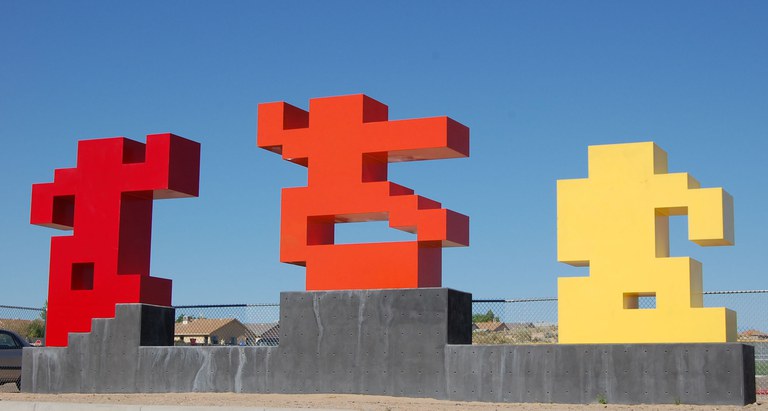 Three pixelated figures representing a skateboarder performing a kickflip. 