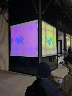 Two sided window installation with multi-colored ink drops suspended in a cube. 