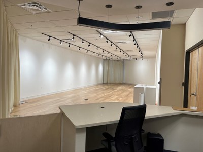 Interior view of the empty gallery from the reception desk area.