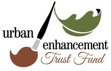 Image of a paintbrush with a leaf at the top and text that reads "Urban Enhancement Trust Fund."