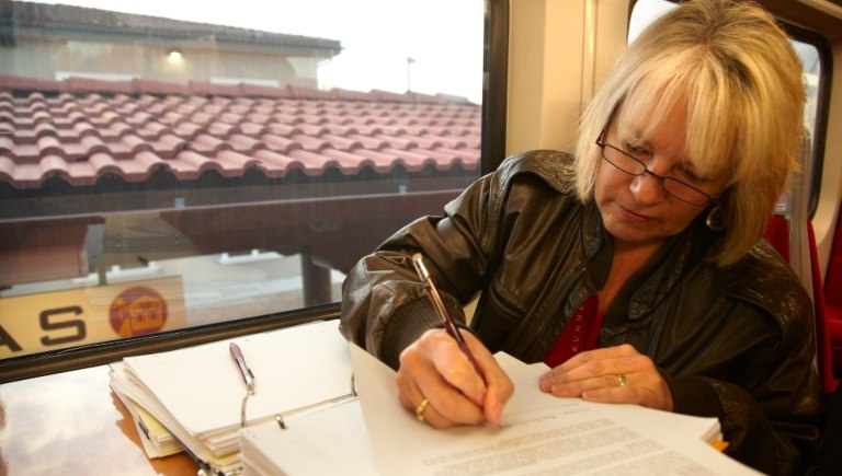 Woman Working While Riding Rail Runner Section Block