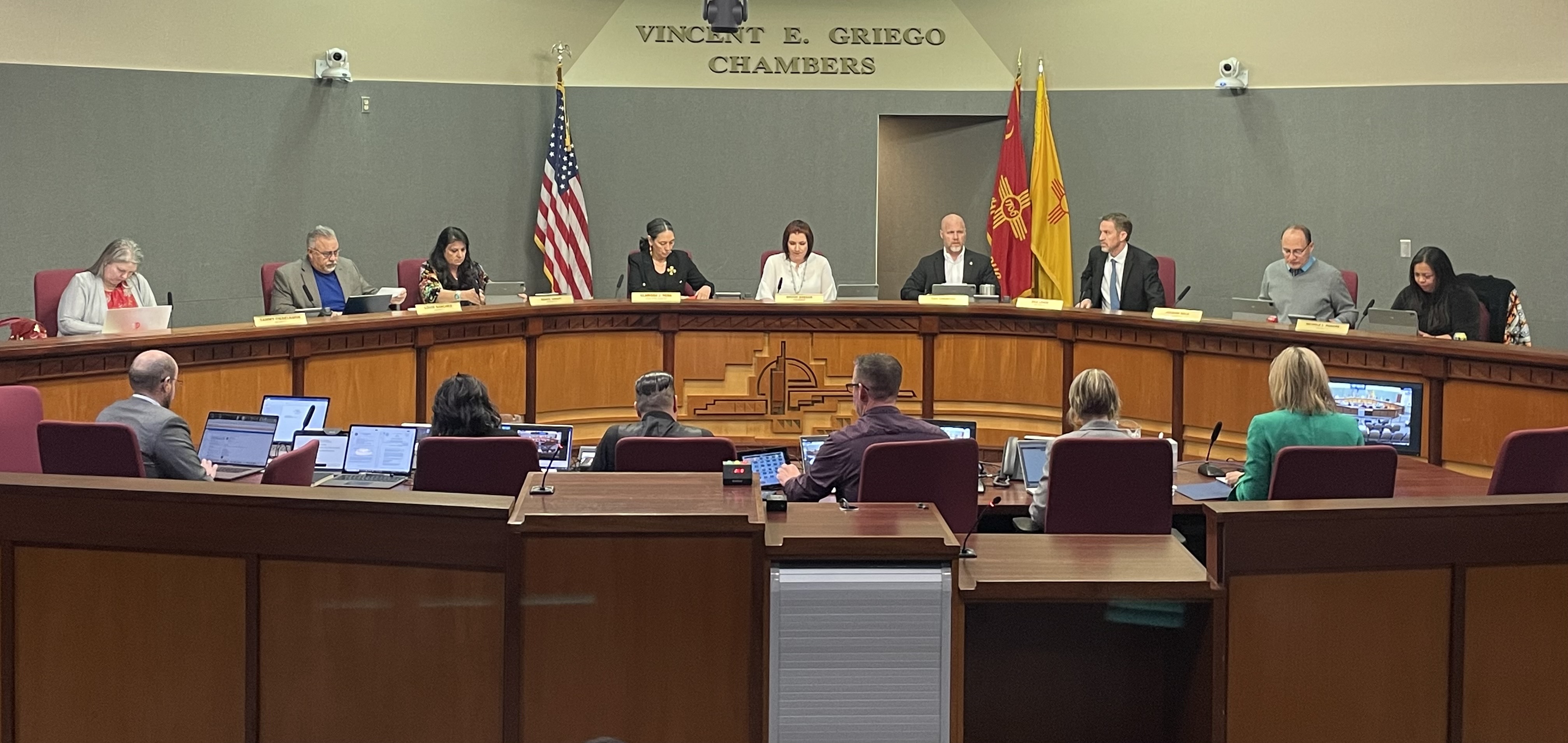 The full city council having a meeting in the Vincent E. Griego Chambers.