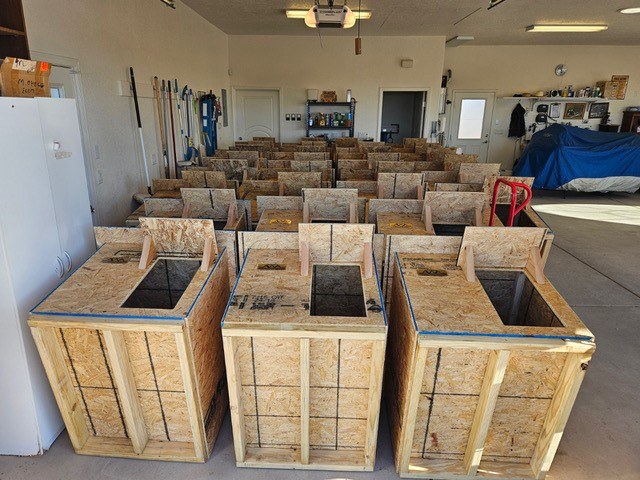 Image of 30 dog houses built by Albuquerque Woodworkers Association