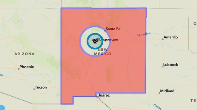 A red map of New Mexico with 2 concentric circles with Albuquerque in the center. There is a blue circle on the inside with an uncolored circle around that.