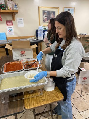 Photo of volunteer serving Posole at Gateway Family Christmas Party