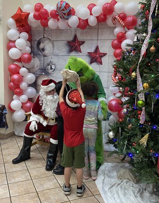 Photo of Santa and the Grinch with children at Gateway Family