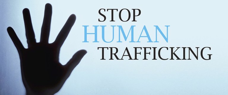 A silhouette of a hand reaching up next to the words "Stop Human Trafficking"