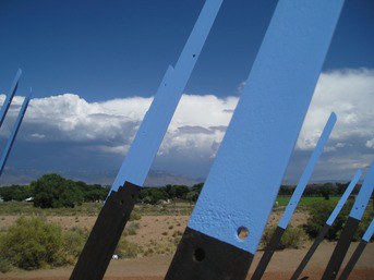 Shiny metal protrusions coming out of the ground.