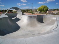 A skate park with a pool and loop.