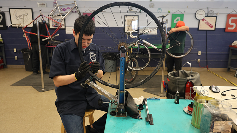 An Esperanza staff member fixing a bike tire.