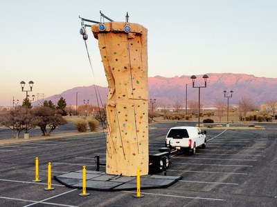 an image of a climbing wall on a trailer connected to a truck.