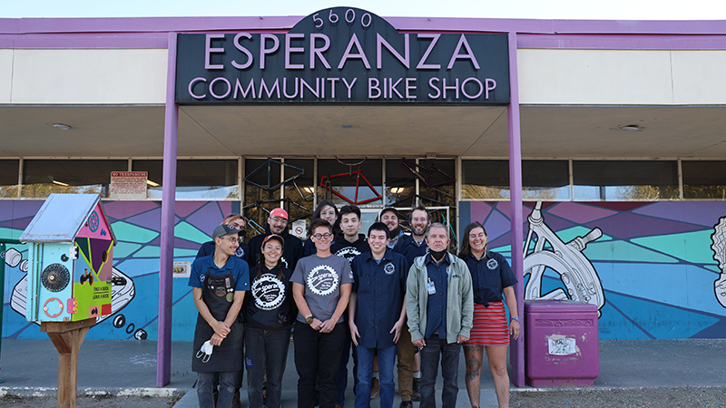 The staff of the Esperanza Community Bike Shop standing outside the building.