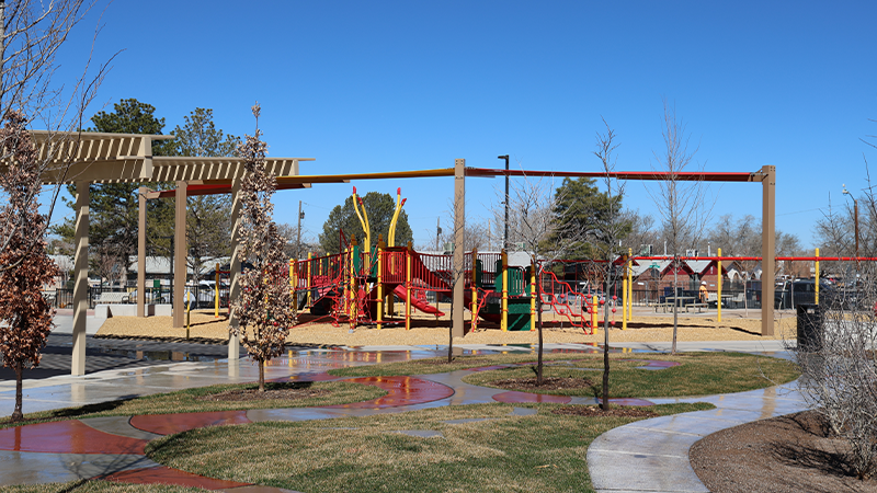 A playground with multiple slides and types of equipment.