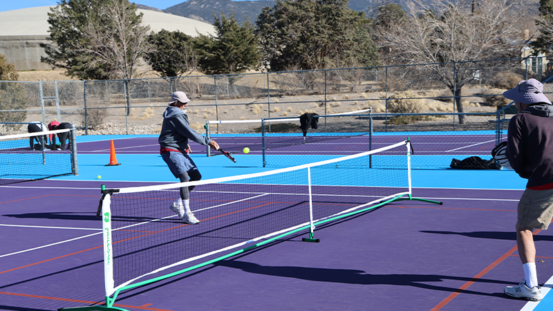 Two people playing pickle ball.