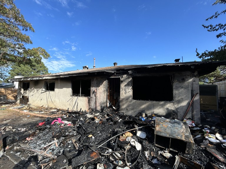 A dilapidated house involved in several fires that is in need of repair or demolition.