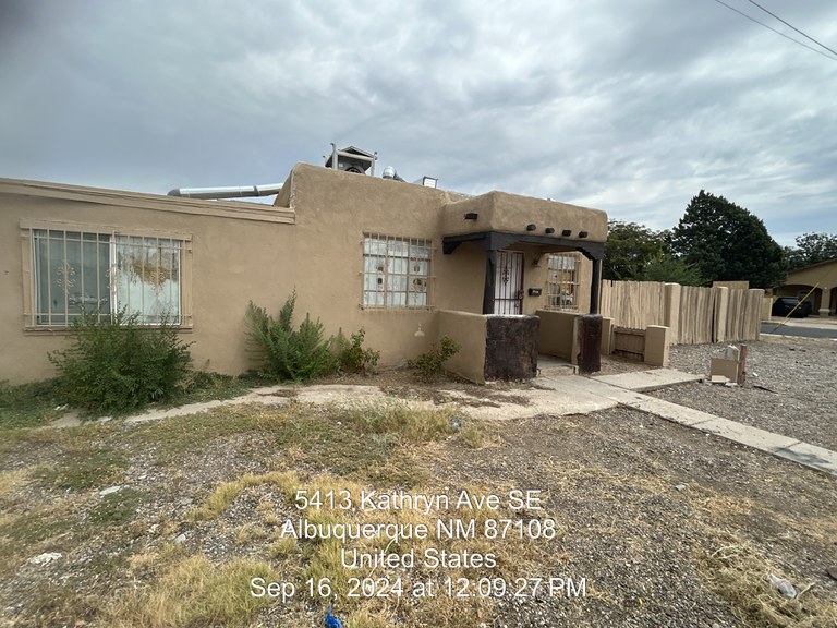 A dilapidated adobe house in need of repair.