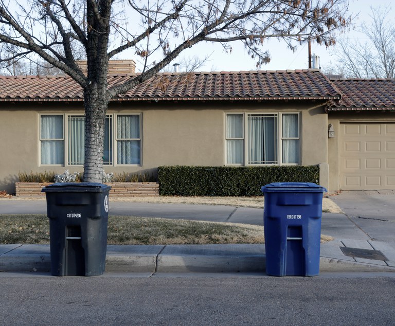 A recycling cart and a trash cart spaced at least five feet apart.